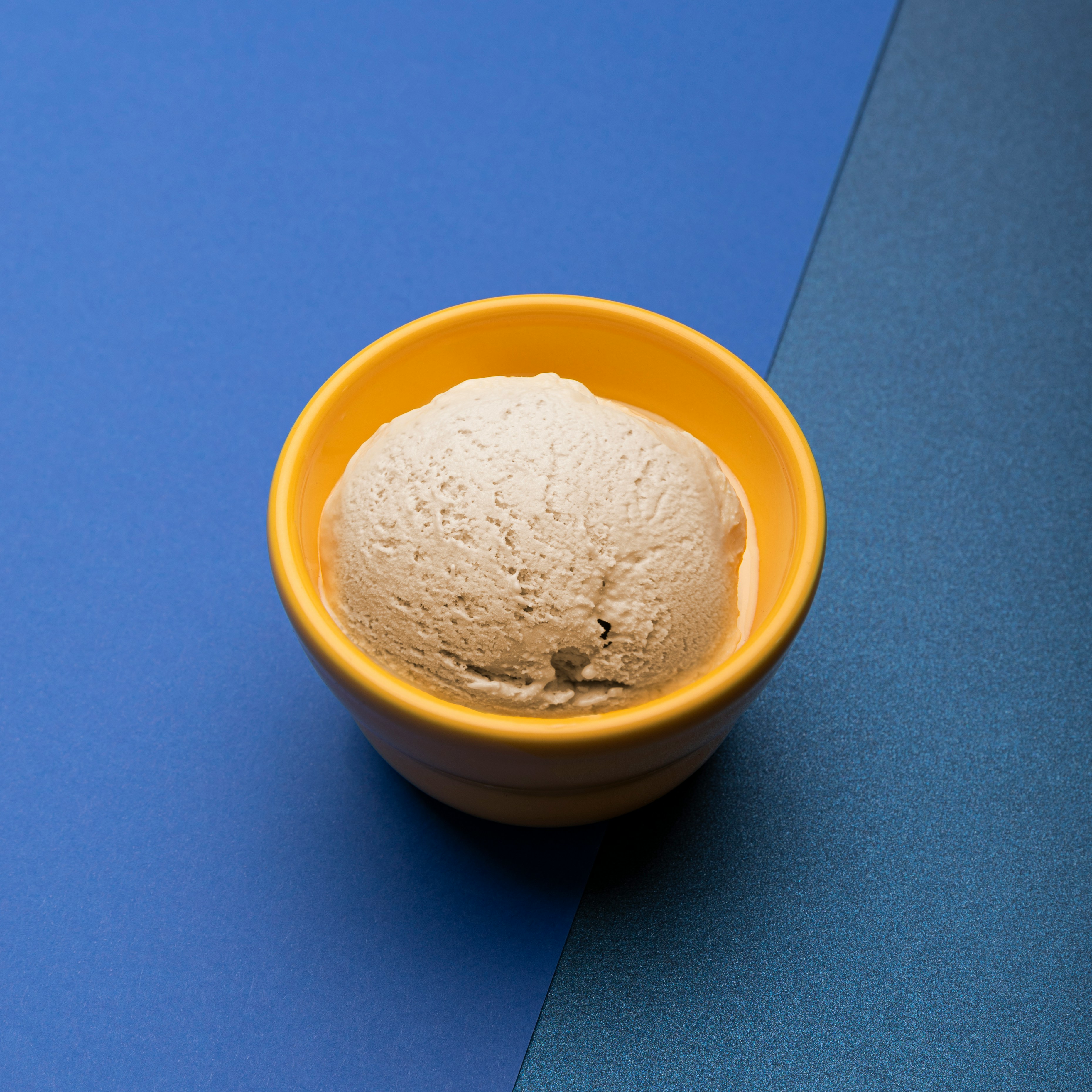 Scoop of banana ice cream in a bowl on a table